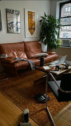 a living room filled with furniture and a laptop computer