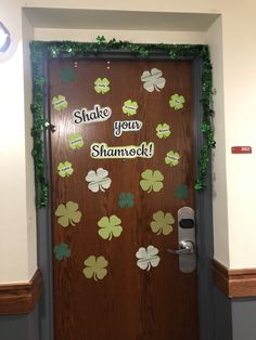 a door decorated with shamrock leaves and the words shake your shamrock