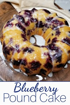 a blueberry pound cake on a plate with the words blueberry pound cake above it