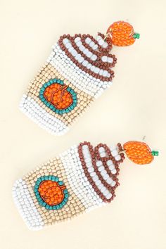 Get a taste of fall with these Pumpkin Latte Dangle Earrings! The perfect accessory for any latte lover, these beaded earrings add a fun and quirky touch to any outfit. Indulge in some seasonal fashion with these playful earrings. (P.S. Pumpkin spice not included!) Seed beaded earrings Dimensions: 1.3 x 3 in (3.3 x 7.6 cm) Ships with love from our warehouse in Smithfield,VA Cute White Beaded Dangle Earrings, Trendy Orange Beaded Earrings For Gift, Seed Beaded Earrings, Thanksgiving Pumpkin, Pumpkin Latte, Fall Earrings, Long Drop Earrings, Sock Gifts, Pumpkin Spice Latte