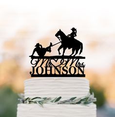 a wedding cake with a horse and rider on top