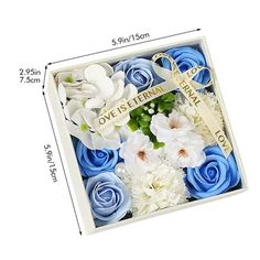 blue and white flowers in a box with a cross on the top, measurements for each flower