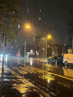 a car is parked on the side of the road in the rain at night time