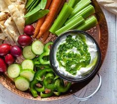 a platter filled with vegetables and dip