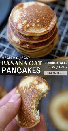 a stack of pancakes sitting on top of a cooling rack next to a hand holding a piece of bread