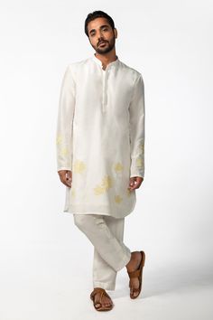 Ivory full sleeve kurta with yellow applique embroidery in geometric pattern and mandarin collared neckline. Paired with pant pyjama.
Components: 2
Pattern: Embroidery
Type Of Work: Applique
Neckline: Mandarin collar
Sleeve Type: Full sleeves
Fabric: Kurta: Bam Silk, Pant Pyjama: Cotton Silk
Color: Ivory
Other Details: 
Front concealed button placket
Occasion: Sangeet - Aza Fashions Yellow Kurta With Floral Embroidery And Long Sleeves, Yellow Long Sleeve Kurta With Floral Embroidery, Long Sleeve Traditional Wear With Tonal Embroidery For Wedding, White Embroidered Traditional Wear With Long Sleeves, White Embroidered Long Sleeve Traditional Wear, Cream Cotton Traditional Wear With Long Sleeves, Fitted Long Sleeve Kurta With Tonal Embroidery, Cream Long Sleeve Cotton Traditional Wear, White Long Sleeve Traditional Wear For Eid