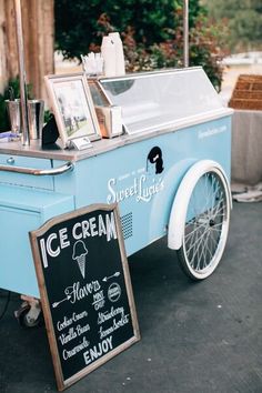 an ice cream cart sitting on the side of a road