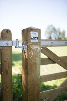 a wooden gate with a sticker on it