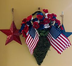 a patriotic arrangement with red, white and blue flowers in the shape of an american flag