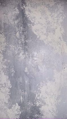 an old dirty wall with some paint peeling off the walls and purple border around it