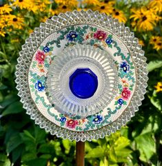 a glass plate sitting on top of a wooden stick