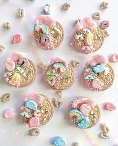 cookies decorated with pastel colors are arranged on a white surface