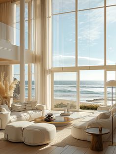 a living room filled with furniture and large windows overlooking the ocean on a sunny day