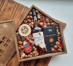 a wooden box filled with liquor and nuts