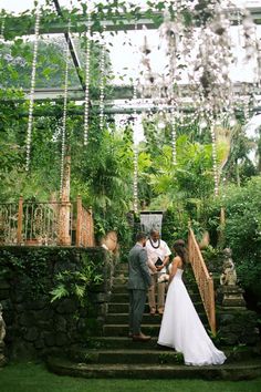 a bride and groom are standing on the stairs