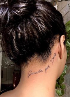 the back of a woman's neck with her name written on it, in cursive writing