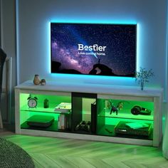 a television that is sitting on top of a cabinet in a room with green lighting