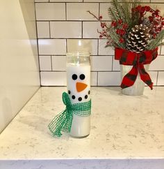 a snowman candle sitting on top of a counter