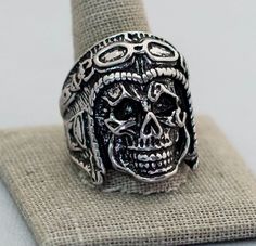 Size 13 1/2 silver tone ring that resembles a skull face with biker helmet. Store Notes - This is the exact item you'll receive!  - USPS first class within 1 business day of purchase.  - Items are packaged in a jewelry box unless they are too big.  - Open to best offer - If you have any questions please ask! Thanks Tags Size 13 1/2, Silver Tone Skull Face Ring, Brutalist Ring, Motorcycle Club Ring, Biker Ring Silver Skull Ring For Biker Events And Halloween, Biker Skull Ring For Biker Events, Vintage Silver Skull Ring For Biker Events, Silver Biker Skull Ring For Biker Events, Brutalist Ring, Biker Helmet, Witch Rings, Rock Rings, Face Ring