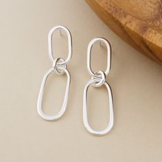 Forged by hand in solid sterling silver, the Paperclip Link Earrings feature elongated oval-shaped dangles that are artfully hammered to a tapered form. The top link features a stud post on the back for a sleek, modern look. These earrings are made-to-order by hand in our bespoke metalsmithing studio in Stockport, New York. Instead of casting multiples of our designs, we fabricate each element by hand the old-school way using torches, hammers, and files on raw silver. Therefore, each pair of ear Silver Earing Design, Modern Earrings With Polished Oval Link, Modern Oval Link Earrings With Polished Finish, Modern Sterling Silver Oblong Earrings, Modern Oblong Sterling Silver Earrings, Silver Oblong Earrings, Handmade Sterling Silver Earrings, Elongated Oval, Link Earrings