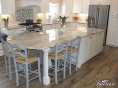 a large kitchen island with chairs around it