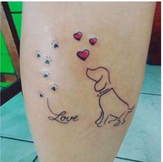 a tattoo on someone's leg that says love and has hearts in the shape of a dog