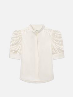 This delicate silk blouse epitomizes modern femininity, featuring a high neckline and boldly puffed sleeves with ruched detailing. We love it tucked into cropped wide jeans with leather slides and a slim belt. Luxury Summer Blouse For Daywear, Elegant Puff Sleeve Top With Gathered Sleeves For Office, Classic Fitted Puff Sleeve Top For Summer, Feminine Fitted Puff Sleeve Top With Pleated Sleeves, Elegant Puff Sleeve Top With Gathered Sleeves For Work, Elegant Fitted Puff Sleeve Top For Work, Classic Fitted Puff Sleeve Top For Daywear, Luxury Spring Daywear Blouse, Chic Spring Puff Sleeve Top For Workwear