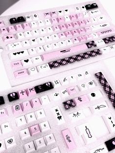 two pink and white keyboards sitting next to each other