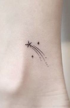 a small star tattoo on the back of a woman's left side ribcage