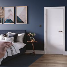 a bedroom with blue walls and wooden floors