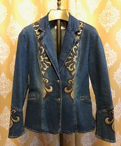 "Regalia" is a beautiful one of a kind fitted denim blazer, hand painted wearable work of art by Jaki Katz Ashford. Approximate size XS. Painted with indelible French fabric paints and embellished with heat set amber colored Swarovski crystals. Medium blue antique wash stretch denim Approximate size 2-4 2 front buttons 2 sewn closed pockets Light shoulder pads Pointed collar middle back Fitted waist Rear vent 24" sleeve from shoulder 16" across back at shoulders 24" length from shoulder in front 36" around bottom Embroidered Fitted Cotton Blazer, Casual Fitted Embroidered Blazer, Trendy Fitted Hand-painted Denim Jacket, Trendy Fitted Hand Painted Denim Jacket, Fitted Western Denim Jacket, Fitted Western Spring Outerwear, Fitted Western Style Spring Outerwear, Fitted Western Outerwear For Spring, Fitted Western Style Outerwear For Spring