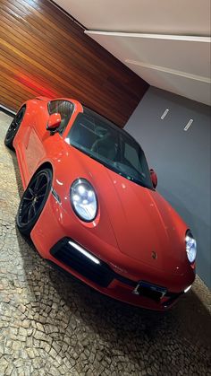 a red sports car parked in a garage