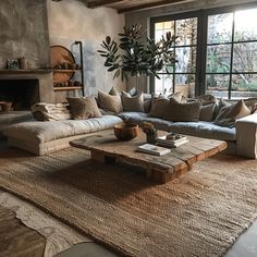 A cozy earthy living room with a woven jute rug, a reclaimed wood coffee table, and stone accents, creating a tactile and inviting atmosphere5 Stone Accents Interior, Jute Rug Living Room Decor, Earthy Living Room Rug, Artisan Living Room, Wood And Stone Coffee Table, Earthy Coffee Table, Organic Vintage Living Room, Cozy Lounge Room, Earthy Homes