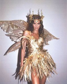 an instagram photo of a woman dressed as a gold fairy with wings and headdress