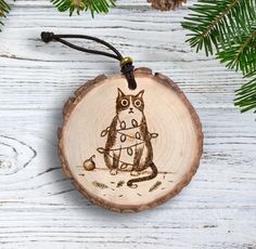 a wooden ornament with an image of a cat on it