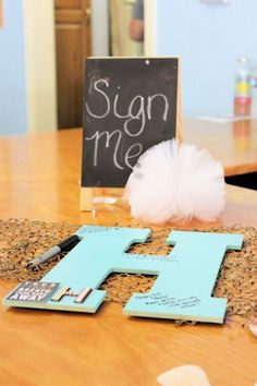 the baby shower ideas for boys are displayed on a table with a sign and tulle