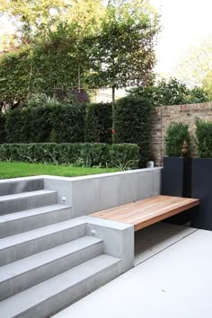 a wooden bench sitting in the middle of a garden