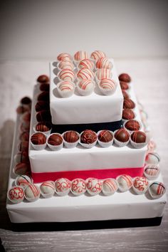 two tiered cake with chocolates and candy on top