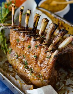 a piece of meat is sitting in a pan with some vegetables on top of it