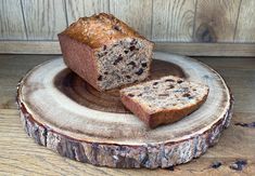 two pieces of bread sitting on top of a wooden plate