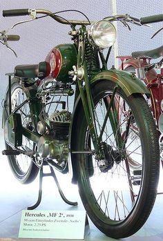 an antique motorcycle is on display in a museum