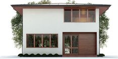 a white two story house with brown shutters on the front and side doors open