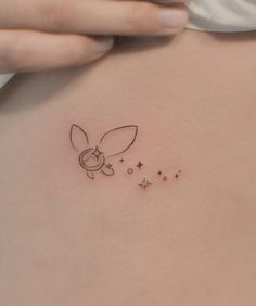 a small tattoo on the back of a woman's stomach