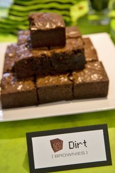 some brownies are stacked on top of each other in front of a name tag