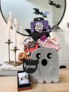 a halloween gift basket with personalized items in front of a mirror on a table