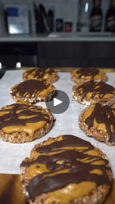 cookies with chocolate and caramel drizzled on them sitting on a table