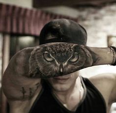 a man with an owl tattoo covering his face