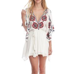 Take A Walk On The Wild Side With The Free People Cora White Embroidered Dress! Intricate Navy Blue, Red, And Beige Embroidery Decorates This Flirty Woven Dress With A Scalloped, Plunging Neckline And Wide, Fluttering Sleeves With Side Slits. Elastic Waistband, And An Tasseled, Wrap Belt Tops A Leg-Baring Mini Skirt. Skirt Is Lined. 100% Viscose. Machine Wash Cold. Imported. Bohemian V-neck Embroidered Dress For Brunch, V-neck Dresses With Embroidered Hem For Brunch, Embroidered V-neck Vacation Dress, White V-neck Embroidered Dress For Festival, Embroidered V-neck Summer Mini Dress, Embroidered Summer Mini Dress, Embroidered Mini Summer Dress, Vacation Mini Dress With Embroidered Hem, Embroidered Summer Dress For Brunch