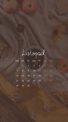 an image of a desktop calendar with apples and sunflowers on the table next to it