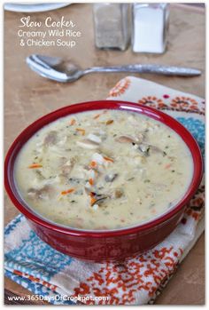 slow cooker creamy wild rice and chicken soup in a red bowl with spoons